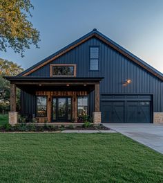 a large house with two garages on the front and side of it, surrounded by grass