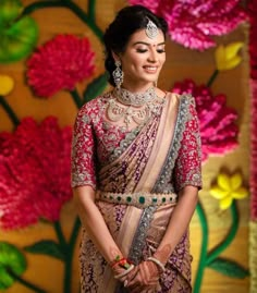 a woman in a bridal outfit standing next to flowers