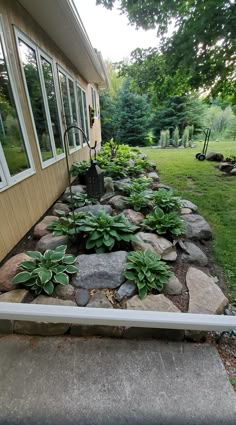 there is a rock garden in front of the house