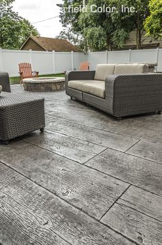 an outdoor patio with wicker furniture and wood flooring