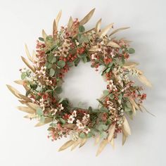 a wreath made out of dried flowers and leaves