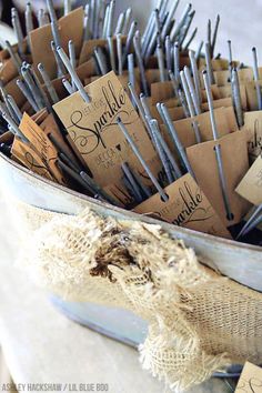 there are many pins in the basket with name tags on them and some burlap