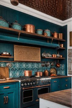 A kitchen with a mix of vintage, modern, and handmade elements that come together to create a cohesive, personalized design. Muted Teal Kitchen Cabinets, Modern Eclectic Kitchen Design, Kitchen Teal Cabinets, Teal Kitchen Ideas, Bohemian Kitchen Design, Peacock Kitchen, Teal Kitchen Cabinets, Colorful Kitchen Backsplash, Blue Backsplash Kitchen