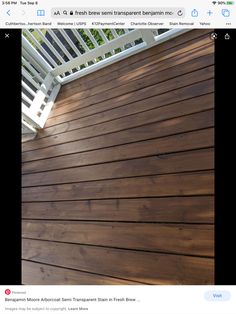 a screen shot of a wooden deck with white railing