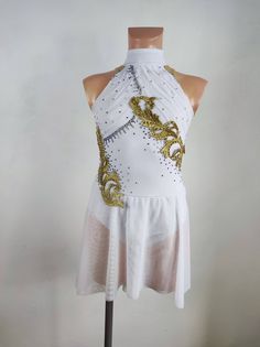 a white and gold dress on a mannequin headdress with sequins