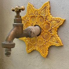 a faucet mounted to the side of a wall next to a yellow star