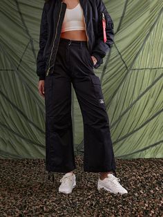 These cargo-style pants are modeled after the US Army M-65 field uniform, one of the most classic military styles to date. The pants include side cargo pockets, drawstring hems, and a double closure waistband for extra security. FEATURES waistband with button and zipper closure drawstring at hem cargo pocket at side seams with hidden snap closure patch pockets on back nylon belt loop detail on wearers left d-ring with alpha red ribbon attached to wearers left back belt loop Military Style Fashion, Gift Guide Women, Cargo Style, Cargo Pocket, Style Pants, Cargo Pant, Military Style, Red Ribbon, Us Army