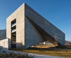 the building is made out of concrete and has a triangular design on it's side