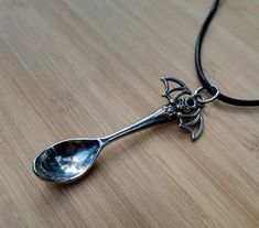 Spooky bat mini spoon pendant handmade in the USA from internationally sourced non-toxic materials.  ☙Limited quantity available!☙ ☙Included in this purchase : silver toned pentacle mini spoon pendant and optional  20'' high quality stainless steel link chain OR 16" adjustable black vegan leather chain.     Pendant size:  Approximately 2 inches long. Measurements can also be seen in the pictures above. Please pay attention to the sizes before ordering!  1 inch = 25.4 millimeters / 2.54 cm  Check out our other designs at  ☛   SPACEDSPOONS.COM Items  may look slightly different on various devices and in person due to screen sizes, calibrations, brightness etc. Spooky Jewelry, Spoon Pendant, Bat Necklace, Jewelry Halloween, Black Vegan, Halloween Accessories, Chain Pendant, Leather Chain, Link Chain