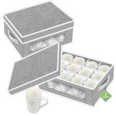 an open box with two mugs inside and one empty cup in the middle next to it