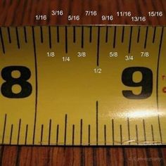 a yellow measuring tape with the number nine on it's side and numbers in black