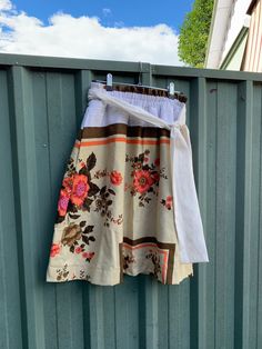 Size S knee length skirt made from a used vintage cotton tablecloth. Double elastic waistband with removable tie. Too good to leave on the table! Measurements (taken while lying flat) Waist: 31cms Length (from top of waistband to hem): 61cms