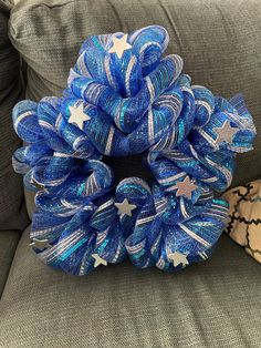 a blue and white wreath sitting on top of a couch