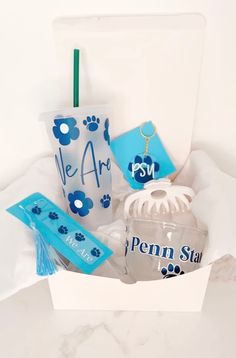 a gift basket with personal items for someone's special occasion, including a sippy cup and keychain