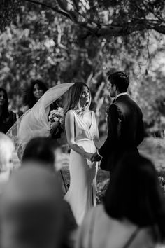 the bride and groom are smiling as they walk down the aisle at their wedding ceremony