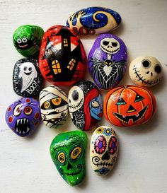 a group of painted rocks sitting on top of a white table next to each other