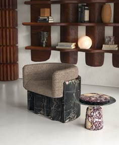 a chair and ottoman in a room with bookshelves