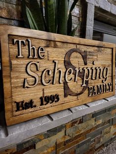 a wooden sign that says the schepping family sitting on top of a brick wall