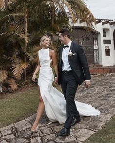 a man and woman in formal wear walking together