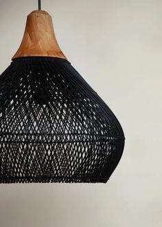 a black and wooden light hanging from a ceiling