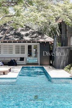 a pool in front of a house with the words dive fish on it's side