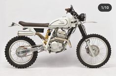 a white dirt bike parked on top of a white floor