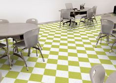 there are many chairs and tables in this room with checkered flooring on the walls