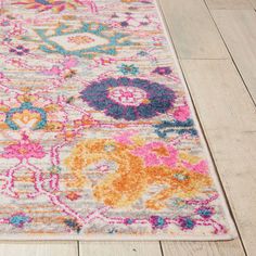 a multicolored area rug with an ornate design on the top and bottom corner