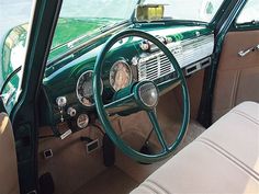 the interior of an old car is green and beige