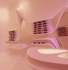 the interior of a futuristic building with pink lighting