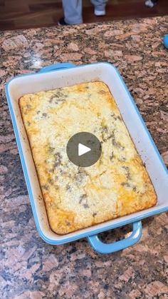 a square casserole sitting on top of a counter next to a blue spatula