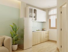 a white refrigerator freezer sitting inside of a kitchen next to a plant in a pot