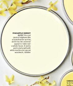 some yellow and white plates with flowers on them