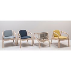 three chairs with different colored cushions and one is made out of wood, while the other has