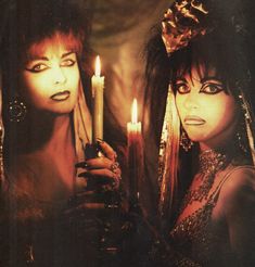 two women holding candles in their hands