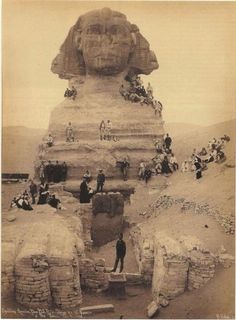 an old black and white photo of people standing in front of the great sphinx