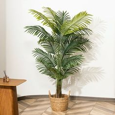 a potted plant sitting on top of a tiled floor next to a wooden table