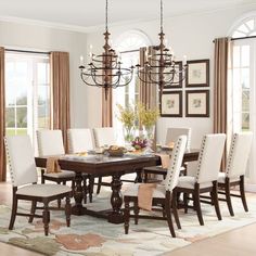 a dining room table with chairs and a chandelier