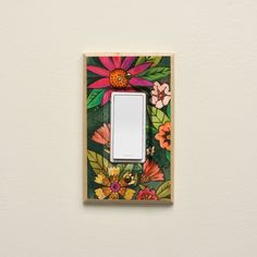 a light switch cover with flowers painted on it