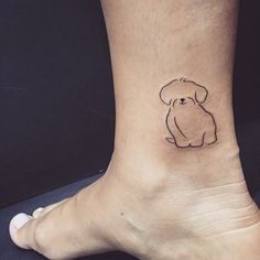 a small dog tattoo on the ankle