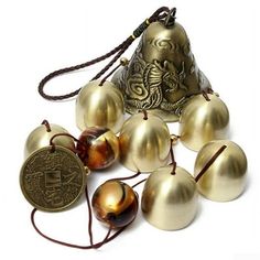 several bells and one coin on a white background