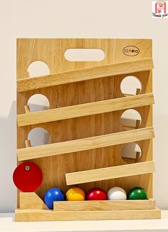 a wooden toy set with balls in it