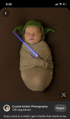 a baby in a star wars outfit with a light saber