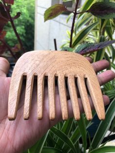 This is a lovely traditional Indian wood comb made out of the beneficial neem tree. It is a lovely wide tooth comb to prevent entangling of hair and will work well for children or people with curly hair.  Neem combs are carbon based, just like your hair, skin and scalp. The massaging of the comb stimulates the follicles too generate more hair strands which increases hair growth.  Neem wood comb has many benefits: 1) Promotes A Healthy Scalp  2) Nourishes The Hair  3) Promotes Hair Growth  4) Prevents Greasiness  5) Prevents Breakage And Hair Loss  6) Improves circulation This is a smaller comb, measuring 10 cm (4 inches) in width and its about 10 cm (4 inches) in height and its about 1 cm (0.39 inches) in thickness.  Please allow 15-17 business days for delivery. Scalp Massage For Hair Growth, Massage For Hair Growth, People With Curly Hair, Aloe Vera For Sunburn, Indian Ayurveda, Ayurveda Hair, Neem Tree, Home Remedies For Warts, Natural Remedies For Migraines