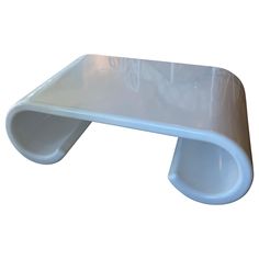 a white plastic shelf sitting on top of a table