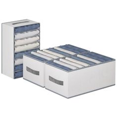 an open drawer with folded clothes in it and two white boxes on the bottom shelf