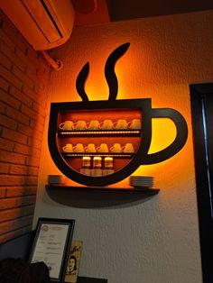 a lit up coffee cup on top of a shelf