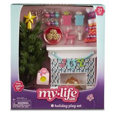 a toy kitchen set with toys and accessories in it's box, including a christmas tree