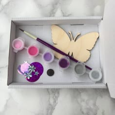 a box filled with crafting supplies and a butterfly cutout