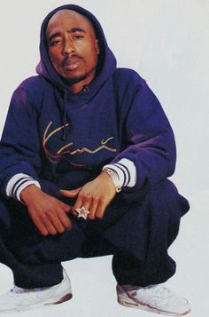 a man in a blue hoodie sitting down